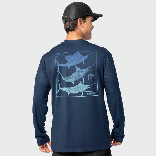 Man wearing a navy long-sleeve shirt with billfish graphic on the back, on a light gray background