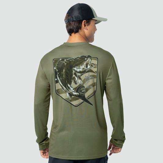 Person wearing a green long-sleeve shirt with a bass fish graphic on the back, standing against a light gray background.