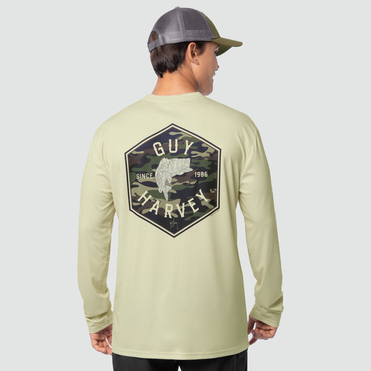 Person wearing a Guy Harvey long-sleeve shirt with a logo on the back against a gray background