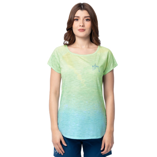Woman wearing a green and blue gradient t-shirt with Guy Harvey signature logo on left chest on a white background