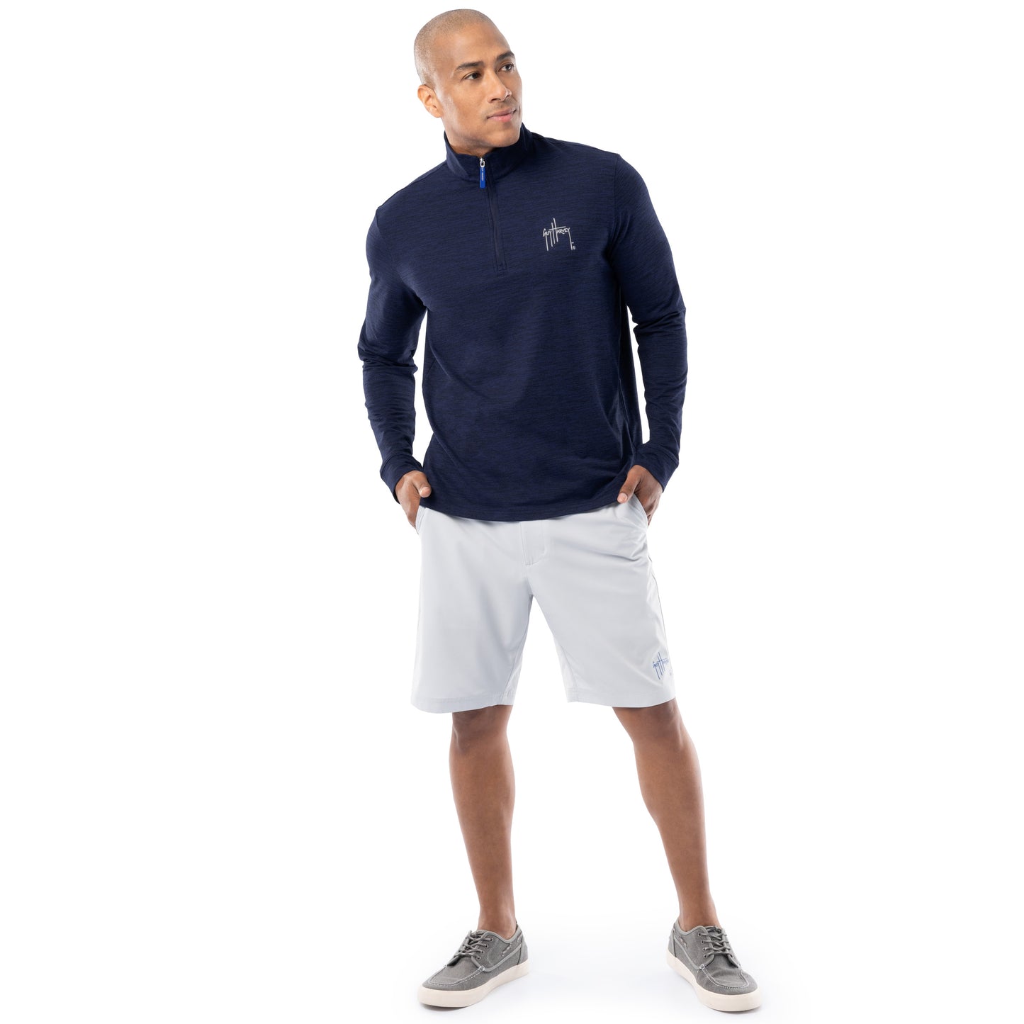 Guy Harvey men’s navy fleece quarter zip pullover styled with light gray shorts, full-body view