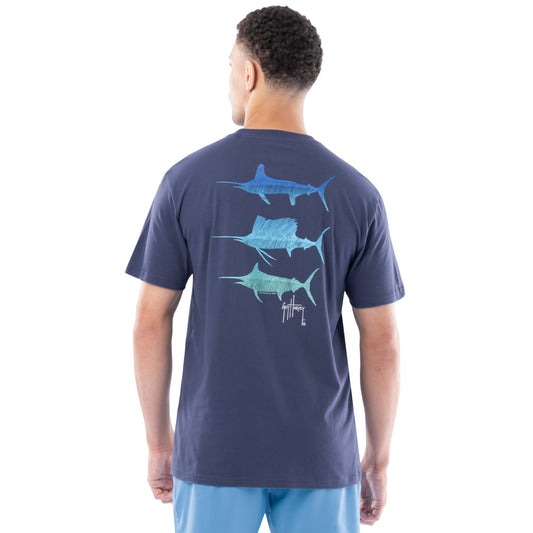 Man wearing a navy blue t-shirt with Marlin and sailfish graphics on the back, standing against a white background.