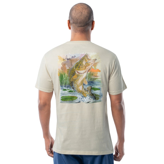 Man wearing a beige t-shirt with a bass fish graphic on the back, standing against a white background