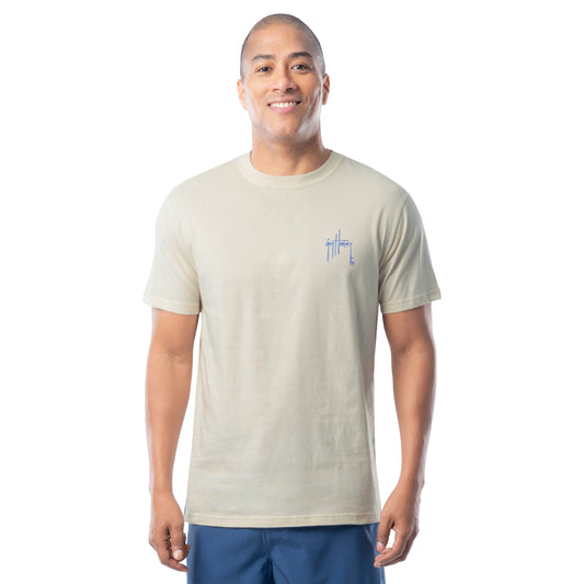 Man wearing a beige t-shirt with a Guy Harvey logo on a white background