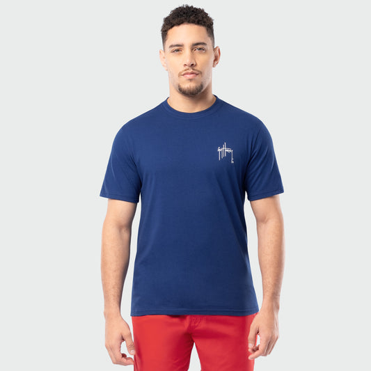 Man wearing a blue t-shirt with a Guy Harvey logo on a white background