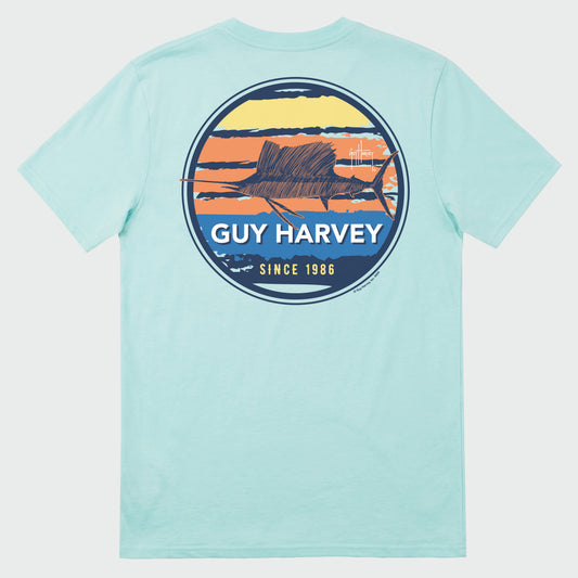 Flat lay image of a light green Guy Harvey t-shirt with a sailfish graphic on the back against a white background