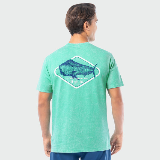Person wearing a green washed t-shirt with a mahi mahi graphic on the back against a white background