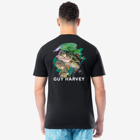 Person wearing a black Guy Harvey t-shirt with a bass design on the back.