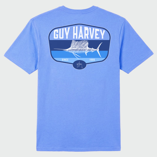Flat Lay image of a blue Guy Harvey t-shirt with a sailfish graphic on the back against a white background