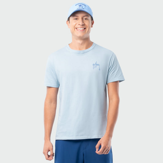 Man wearing a light blue t-shirt and cap on a plain background