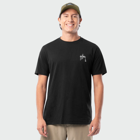 Man wearing a black t-shirt with a Guy Harvey logo on a white background
