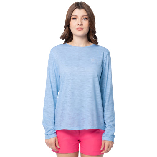 Woman wearing a light blue long-sleeve shirt and pink shorts on a white background