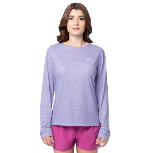 Woman wearing a purple long-sleeve shirt and pink shorts on a white background