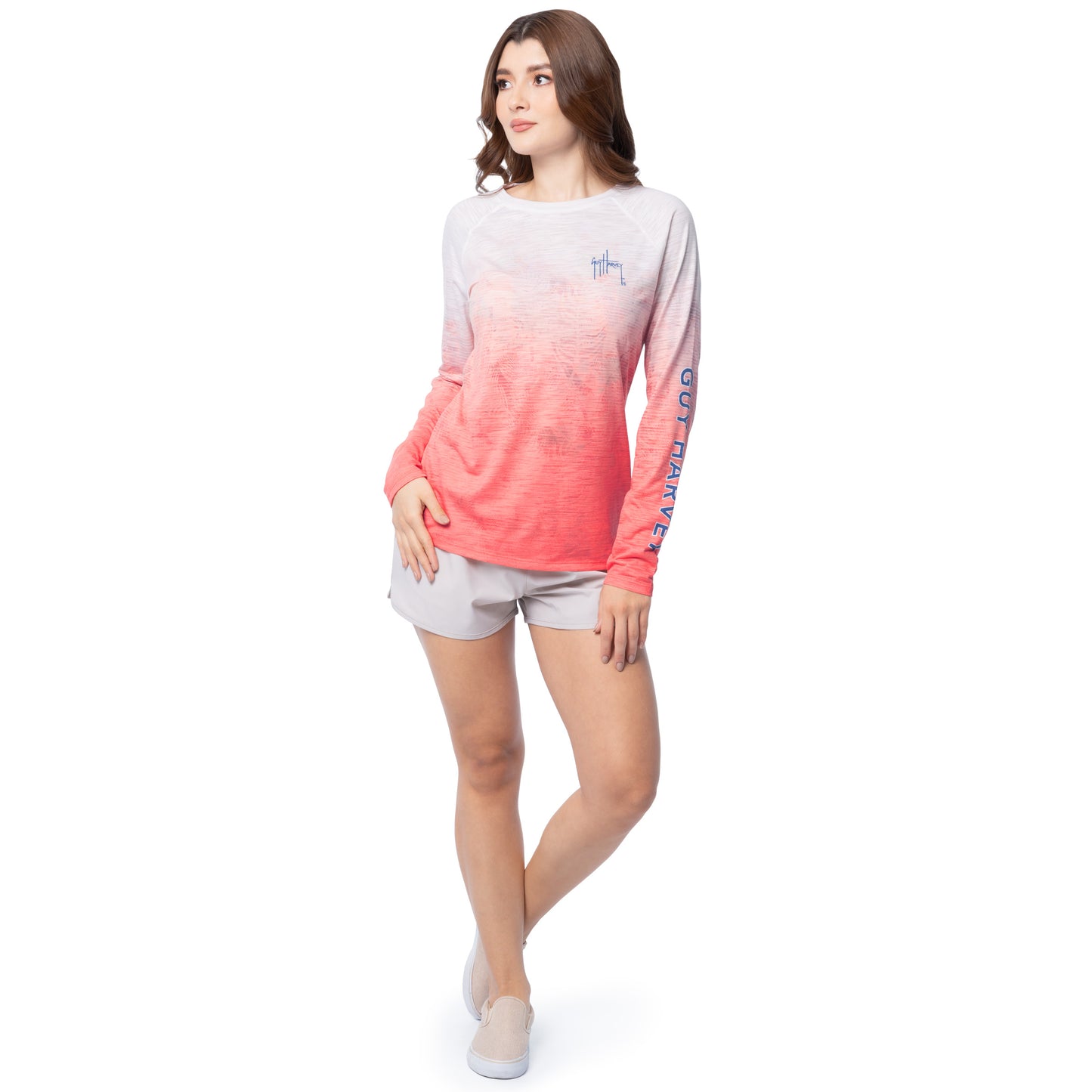 Woman wearing a long-sleeve shirt with a gradient design and shorts on a white background