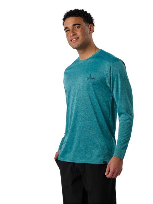 Man wearing a teal long-sleeve shirt with a logo on a white background