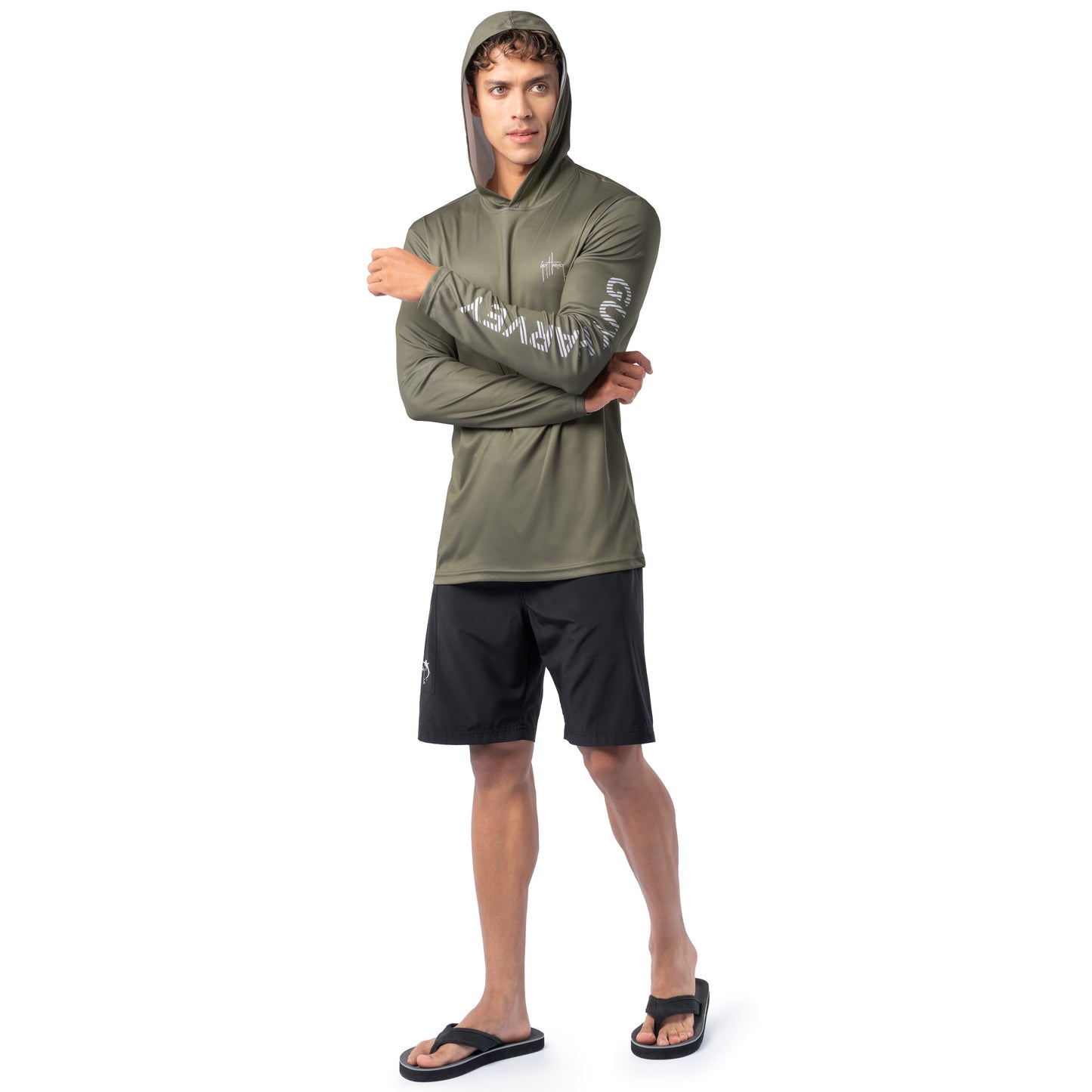 Model wearing olive green Guy Harvey Men’s Freshwater Fantasy Sun Protection Hoodie with hood up in casual fishing-inspired look.