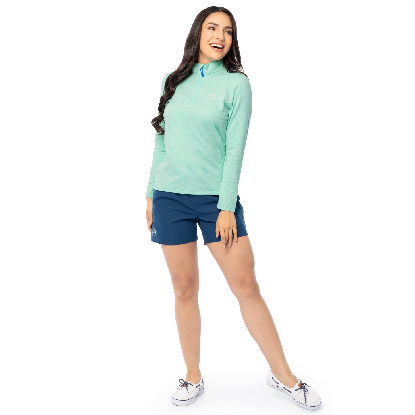 Full body view of woman wearing Guy Harvey Green Pullover with navy shorts