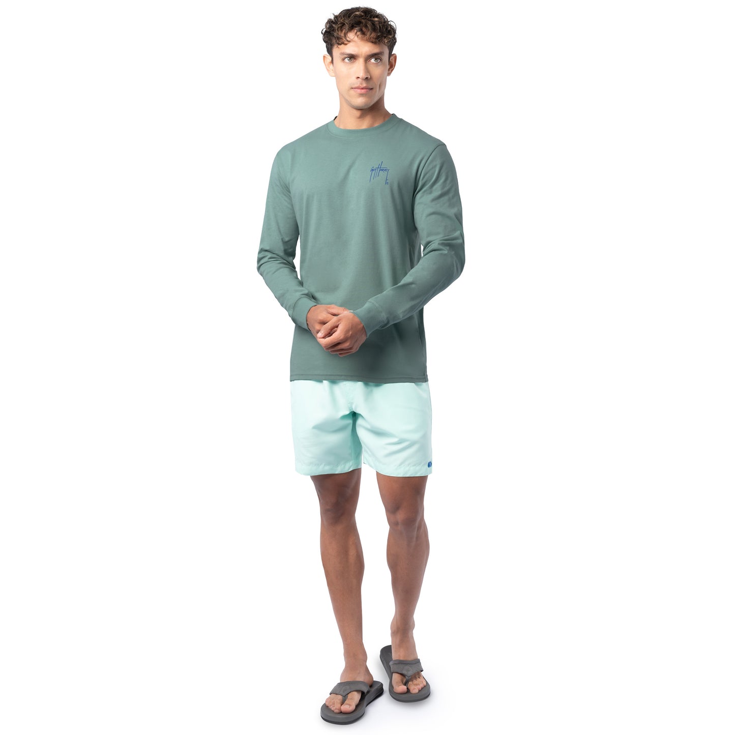Lifestyle photo of model wearing Guy Harvey Men’s Saltwater Paradise Lightweight Long Sleeve Tee near the water
