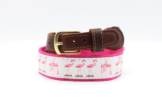 Guy Harvey Men’s Flamingo Leather Tab Belt with pink flamingo illustrations on white cotton webbing, brown leather tabs, pink trim, and brass buckle