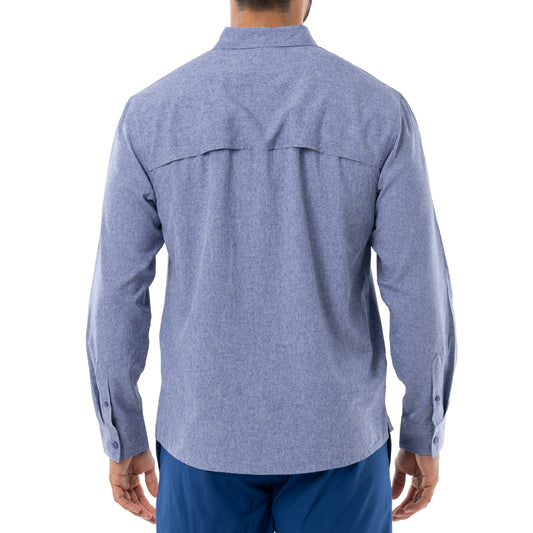 Back view of A man wearing a long sleeve blue heather textured performance fishing. Ventilated back is shown