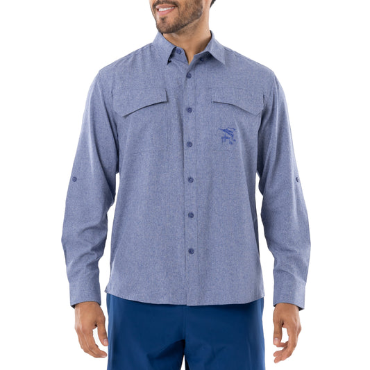 A man wearing a long sleeve blue heather textured performance fishing shirt with a collared neckline and double breast pockets, featuring Guy Harvey artwork on the chest.