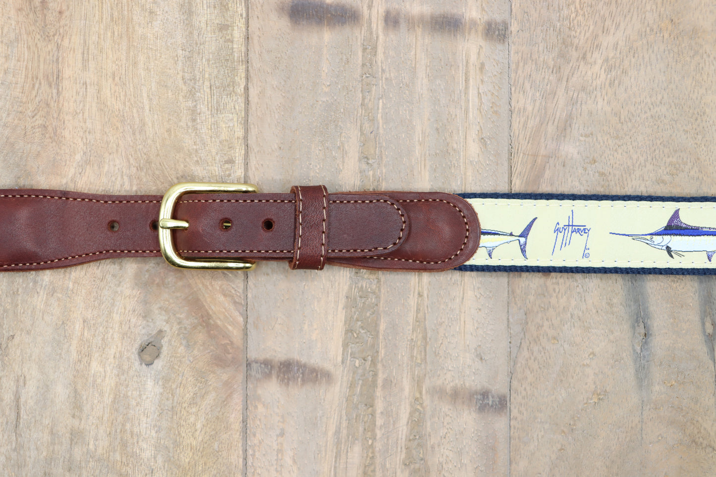 Zoom on the brown leather tabs, and brass buckle.