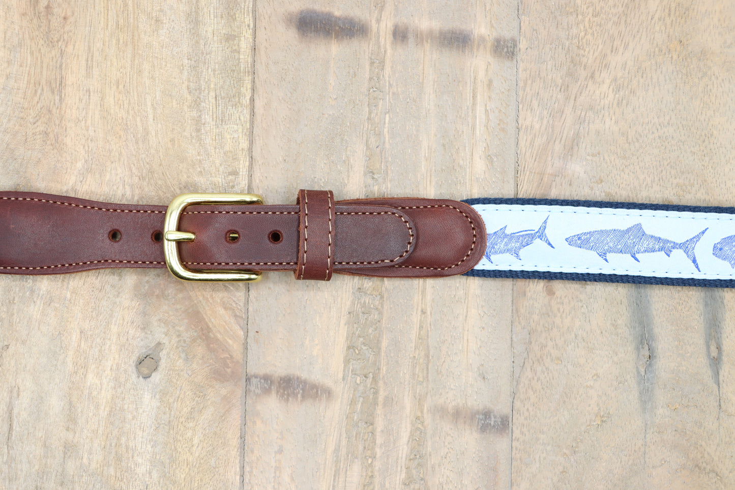 Zoom on the brown leather tabs, and brass buckle