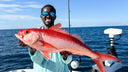 Emmanuel Williams with a brilliant pink fish