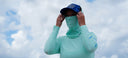 A woman wearing a Guy Harvey Marlin Air Gaiter and Hat.