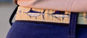 A closeup on a Guy Harvey leather tab belt