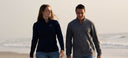 A couple walking on the beach wearing quarter zips from Guy Harvey