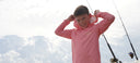 A kid wearing an Eco Cast sun protection hoodie from Guy Harvey