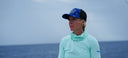 A woman wearing a Guy Harvey hat and Marlin Air Gaiter