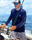 A man holding a fishing reel on a boat on the ocean