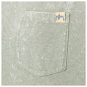 Close-up of a light sage green textured fabric pocket with a small beige brand tag reading Guy Harvey.