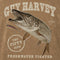 Vintage-style illustrated graphic featuring a large northern pike fish with open mouth, a small fishing lure, and distressed text reading 'GUY HARVEY', 'THE FIFTY CLUB', and 'FRESHWATER FIGHTER' on a brown textured background.
