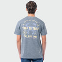 A man viewed from behind wearing a heather blue it-shirt with a vintage-style blue and yellow crab graphic on the back, paired with blue jeans, against a light gray background.