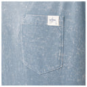 Close-up of a light blue denim shirt featuring a single front patch pocket with a white brand label that reads 'Guy Harvey'.