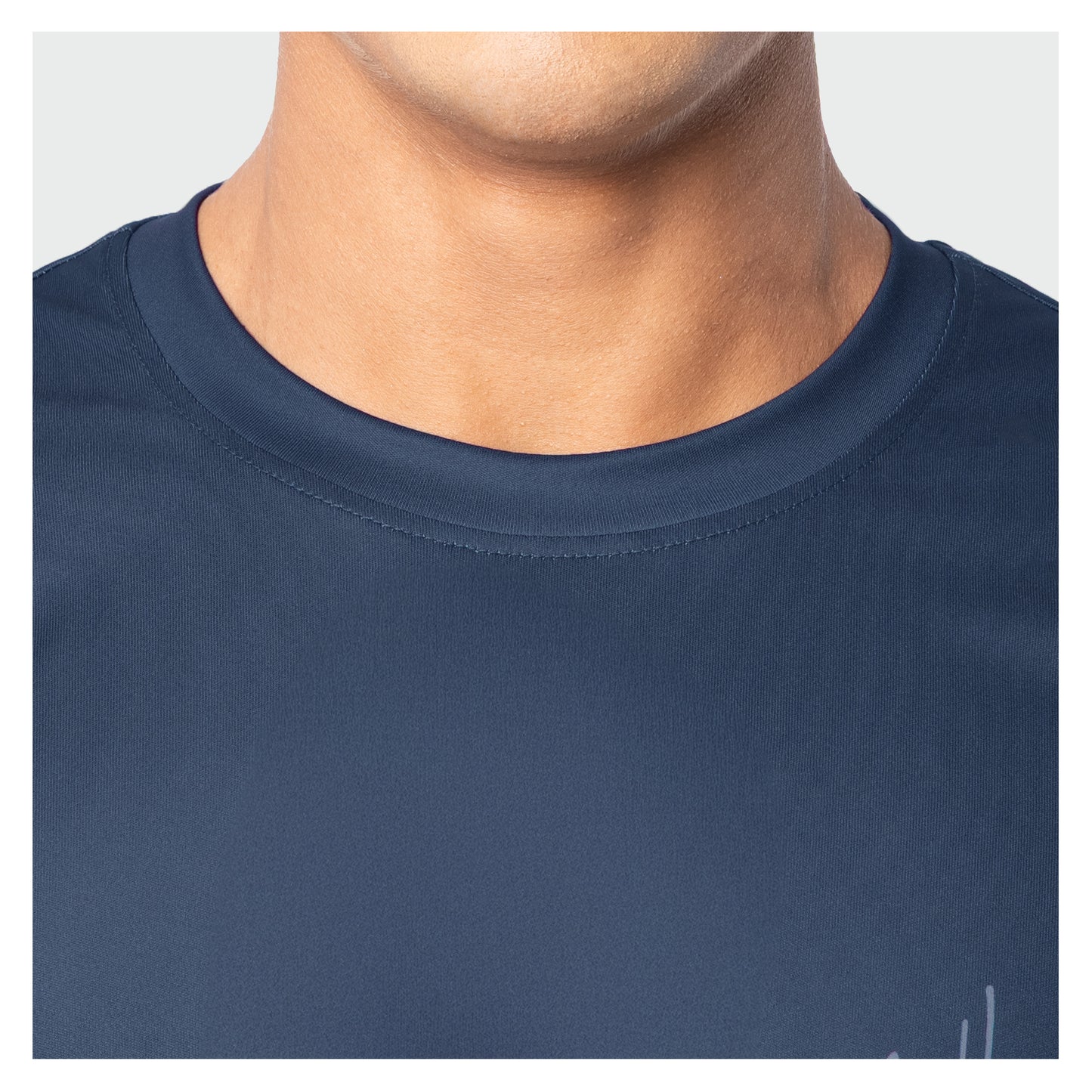 Navy blue t-shirt worn by a person on a light gray background