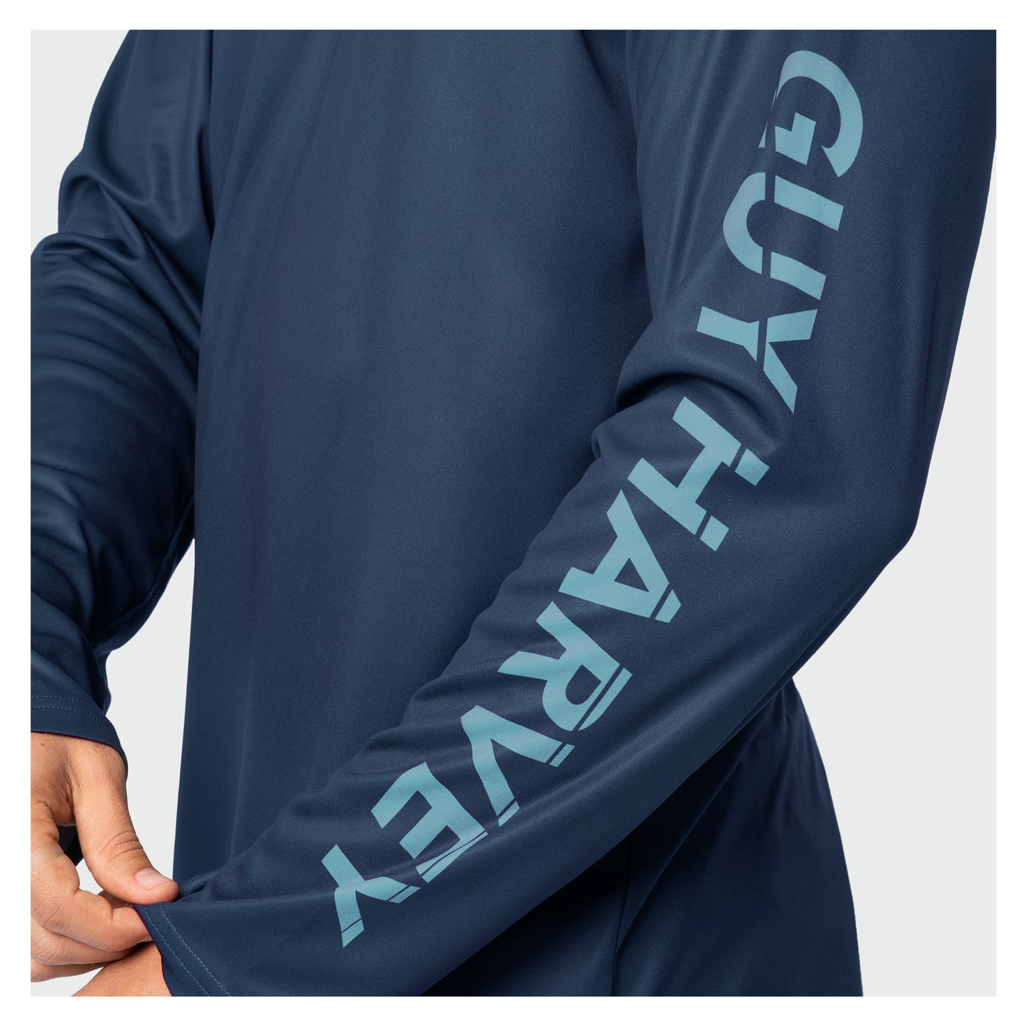 Navy long-sleeve shirt with 'Guy Harvey' branding on a white background