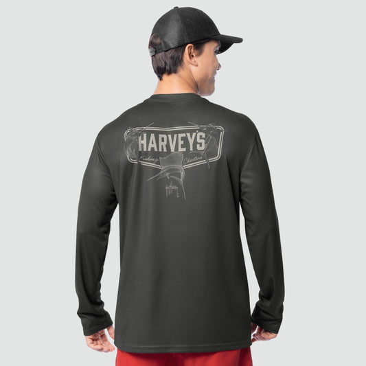 Person wearing a black long-sleeve shirt with 'Harveys' logo on the back, standing against a light gray background.