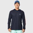 A man wearing a dark navy long-sleeve hooded performance shirt with a small white script logo on the left chest and a red/orange patterned sleeve, paired with a blue cap and mint green shorts, against a light gray background.