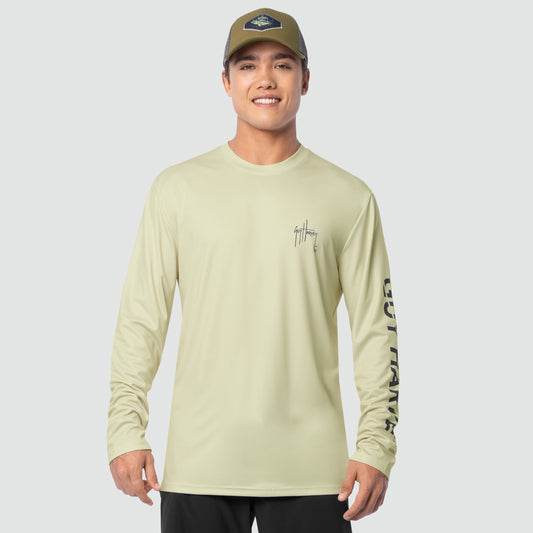 Man wearing a bone white long-sleeve shirt with a Guy Harvey logo on a gray background