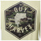 Camouflage bass graphic with 'Guy Harvey' branding on a beige background