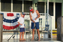 Father and son wearing Guy Harvey t-shirts fishing from a dock