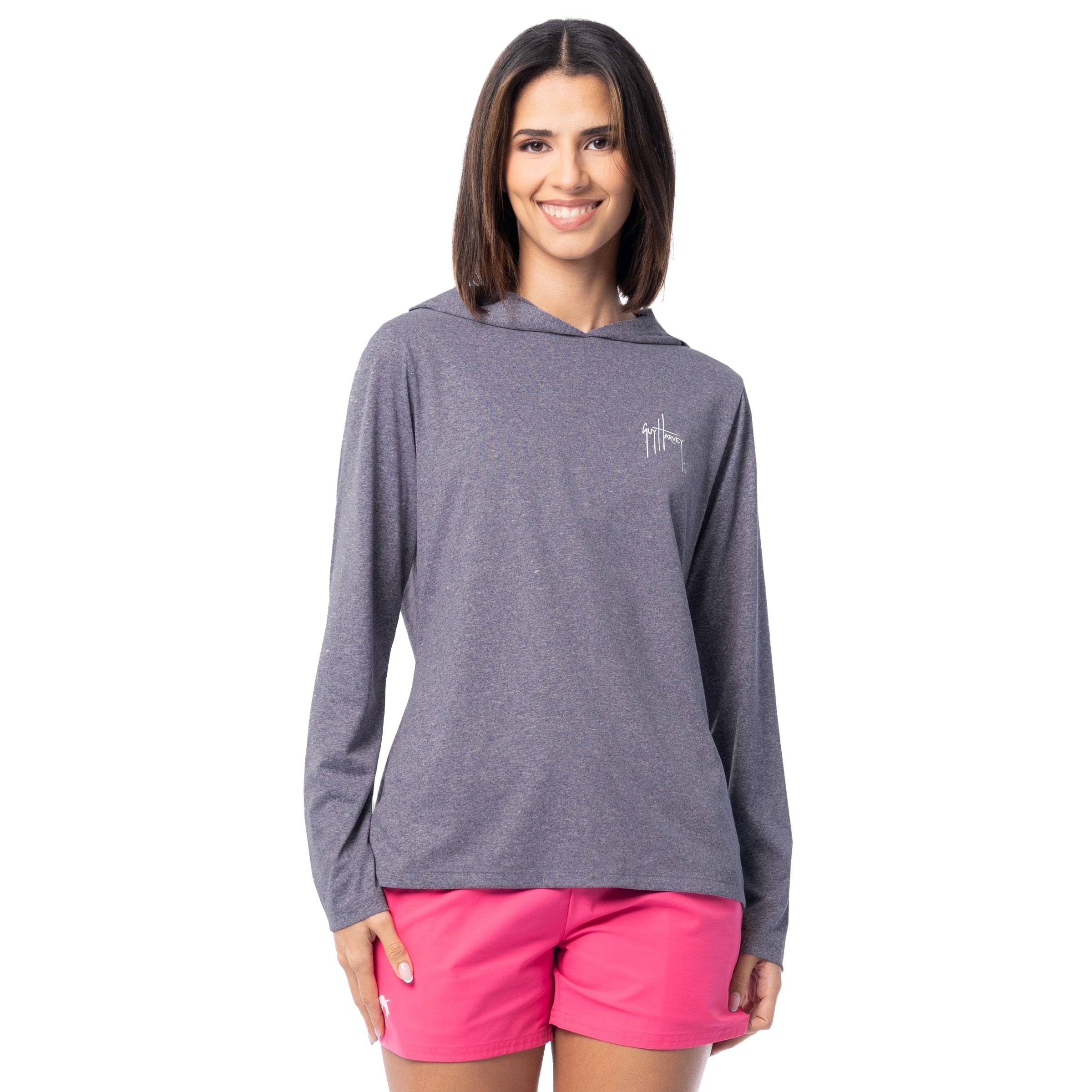 Woman wearing a gray hoodie and pink shorts on a white background