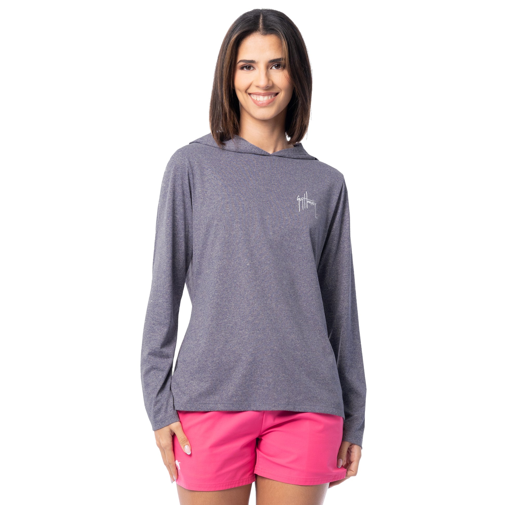 Woman wearing a gray hoodie and pink shorts on a white background