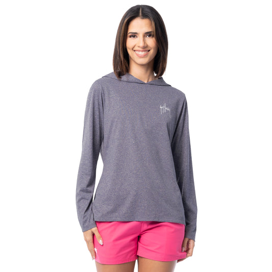 Woman wearing a gray hoodie and pink shorts on a white background