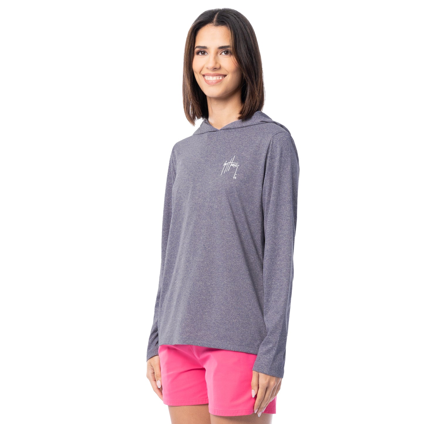 Woman wearing a gray hoodie with a logo and pink shorts on a white background