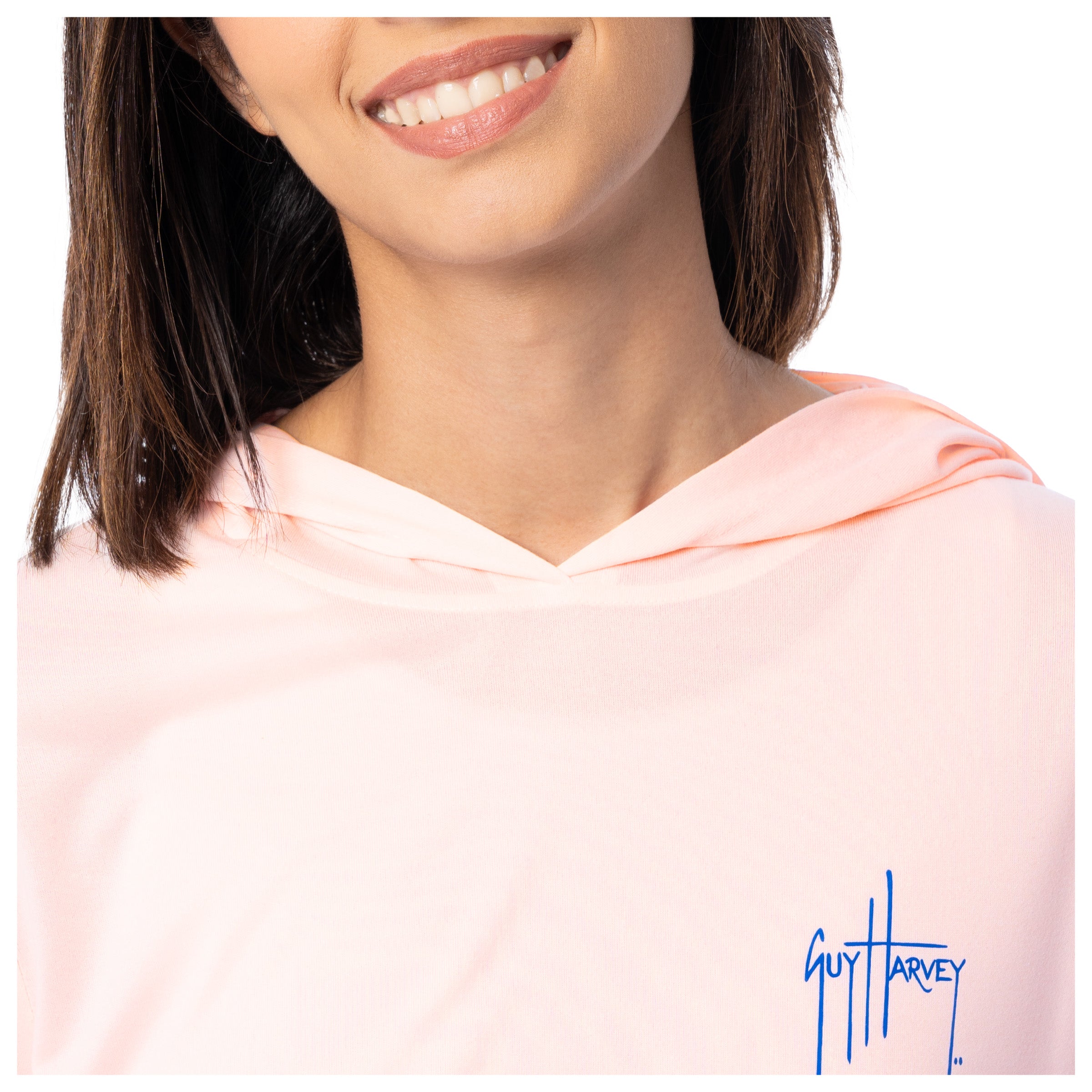 Close-up of a person wearing a pink hoodie with 'Guy Harvey' logo.
